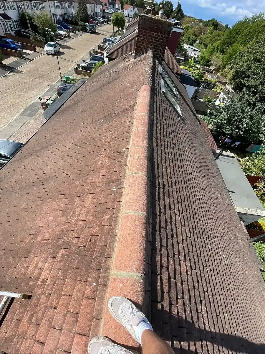 A person standing on top of a roof.