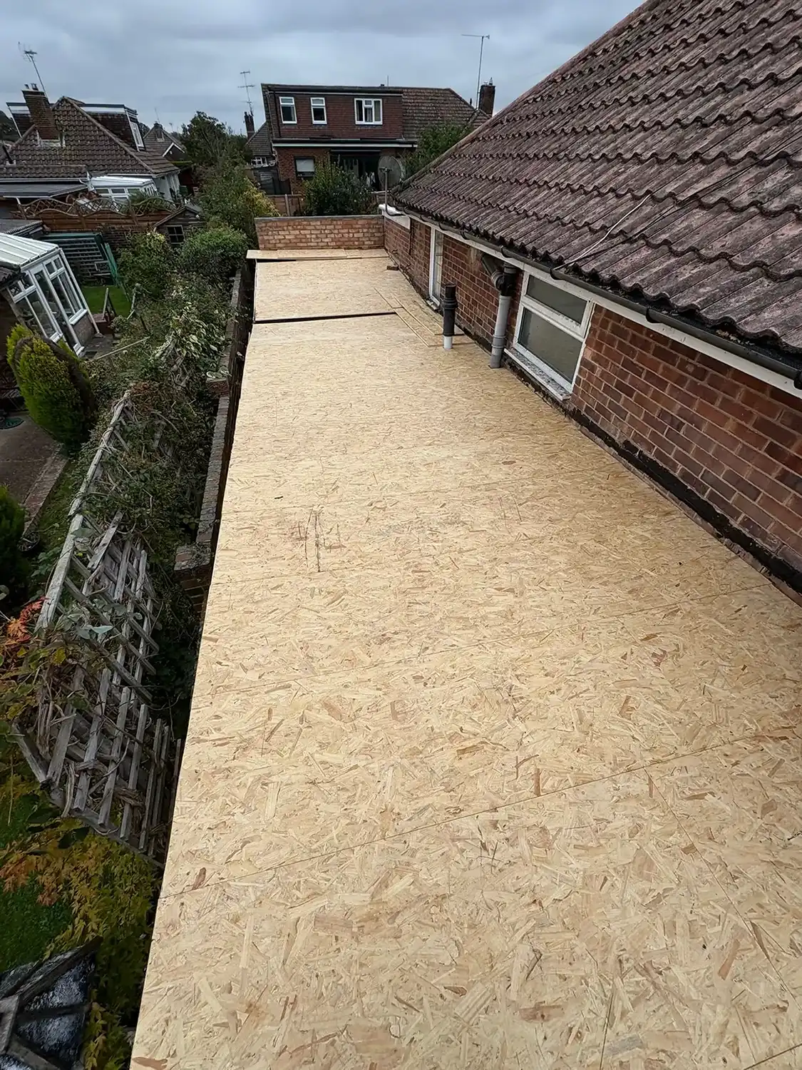 A roof that has been covered with plywood.