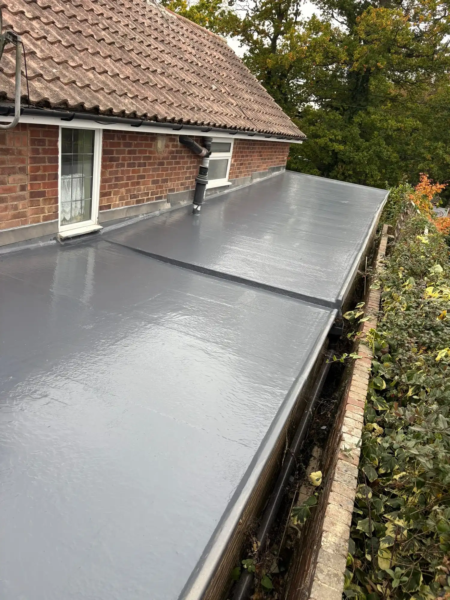 New flat roof on side extension.