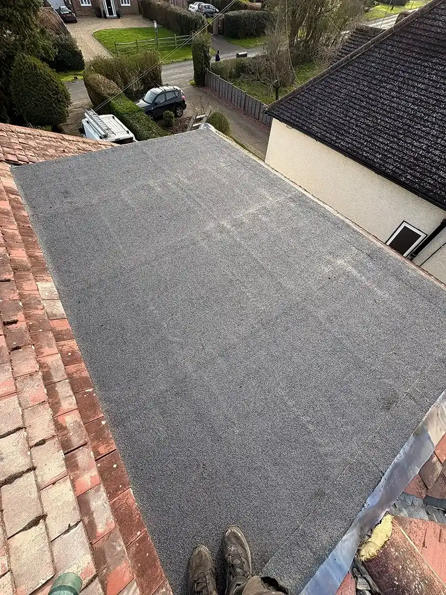 Man standing on the edge of a new flat roof.
