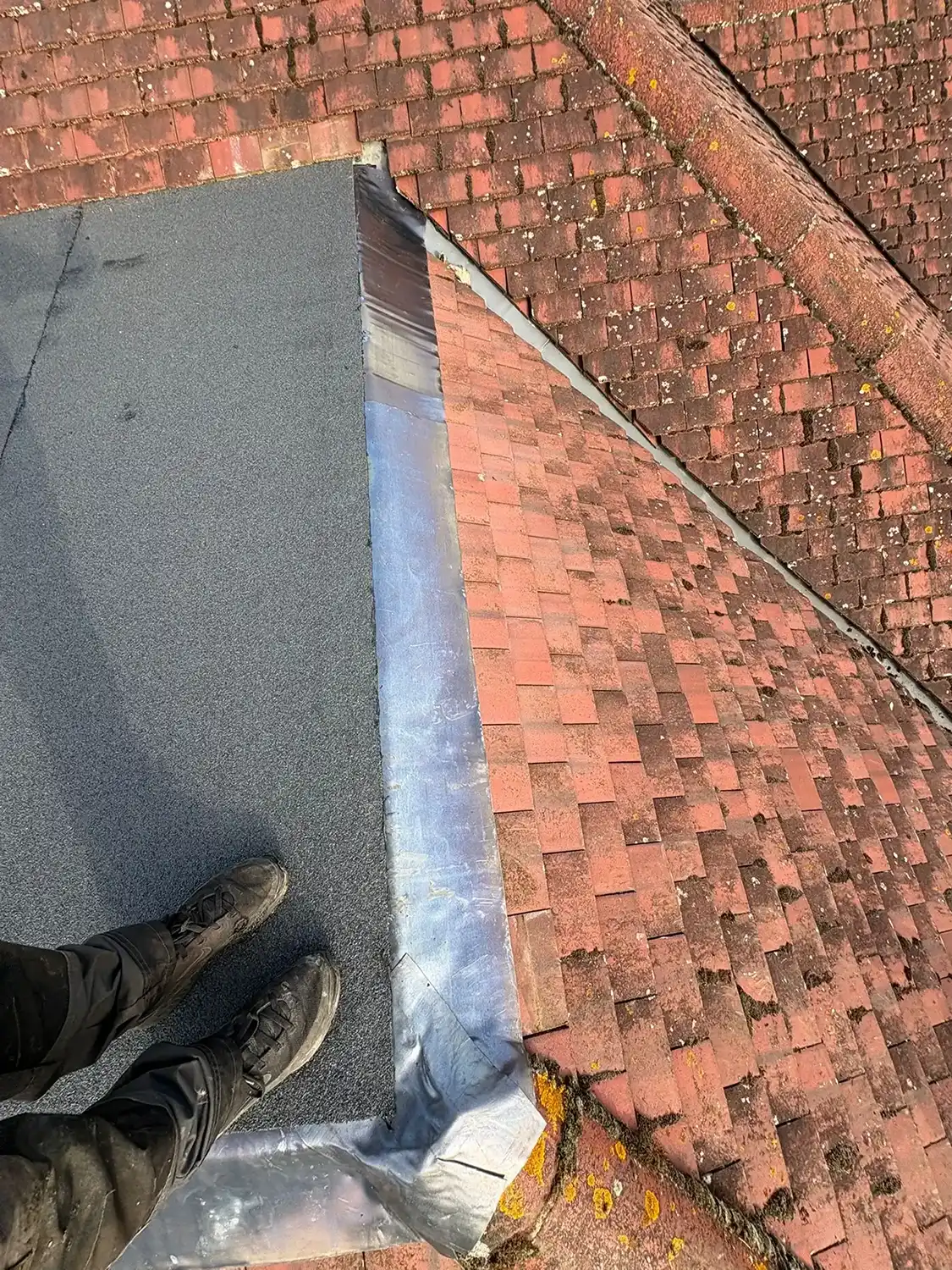 Man standing on new flat roofing.