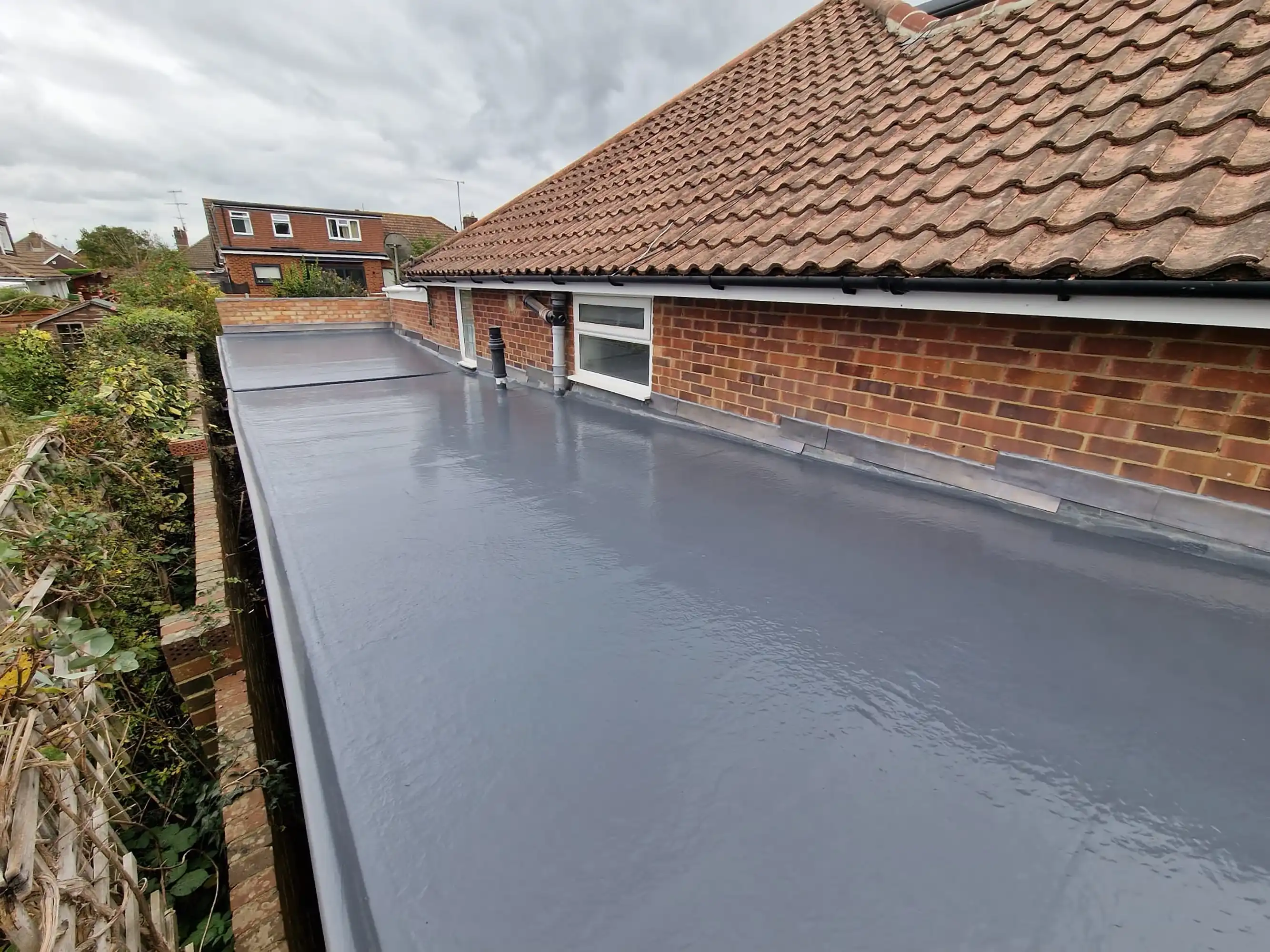 New flat roofing on side of house.